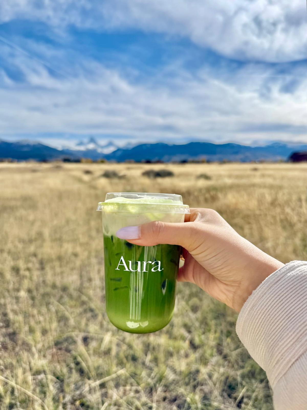 Green matcha drink with mountain landscape